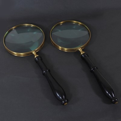 Lot 661 - A plated magnifying glass, together with...