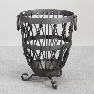 Lot 138 - A wrought iron log basket, 61cm high