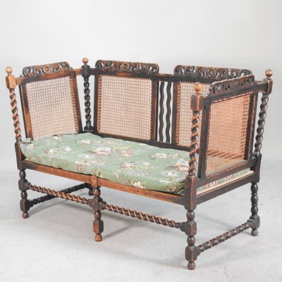 Lot 53 - A 1920' s oak single cane sofa, with a cushion...