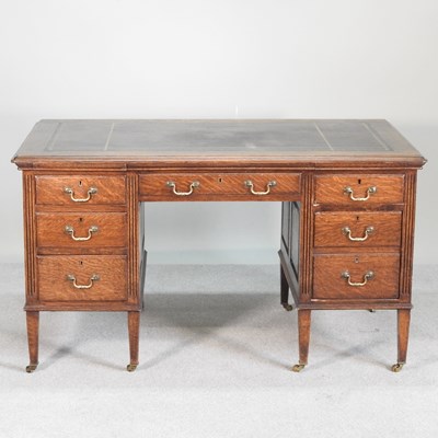 Lot 632 - An Edwardian oak pedestal desk, with an inset...