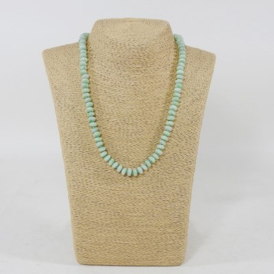 Lot 274 - A jade coloured stone single strand bead...