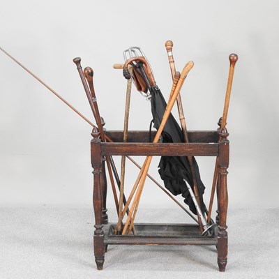 Lot 86 - An early 20th century oak stick stand,...