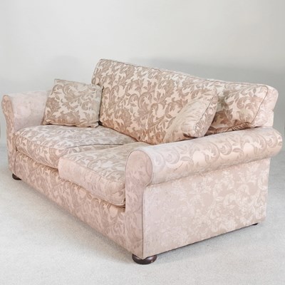 Lot 120 - A modern tan floral upholstered two seater...