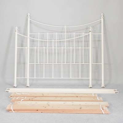 Lot 635 - A cream painted double bedstead, with a...
