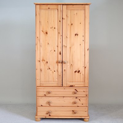 Lot 347 - A modern pine wardrobe, with drawers below