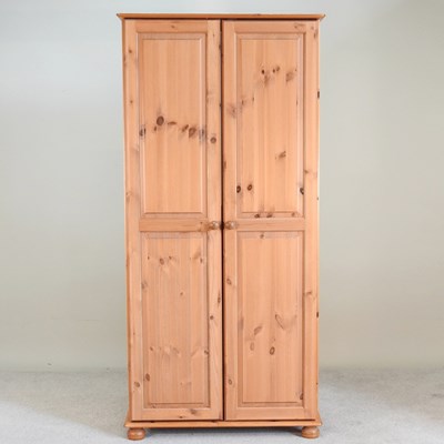 Lot 478 - A modern pine wardrobe, enclosed by panelled...
