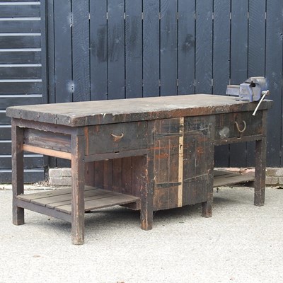 Lot 623 - A large wooden workshop bench, fitted with a vice