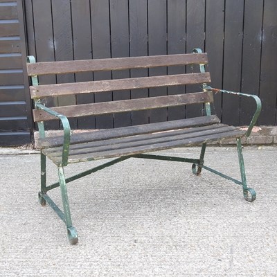 Lot 495 - A metal garden bench, with a slatted wooden seat