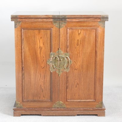 Lot 73 - A modern Chinese elm drinks cabinet, with a...