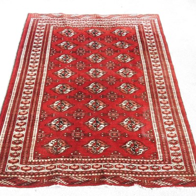 Lot 375 - A Bokara rug, with ivory coloured medallions,...