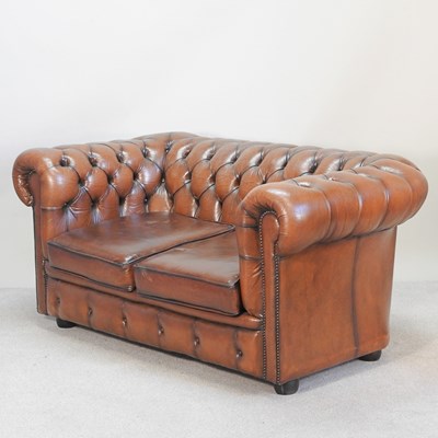 Lot 348 - A tan leather upholstered chesterfield sofa,...