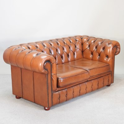 Lot 344 - A tan leather upholstered chesterfield sofa,...