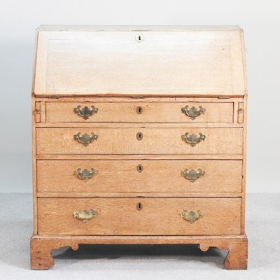 Lot 163 - A George III oak bureau, on bracket feet