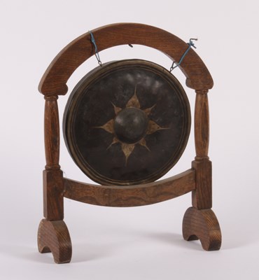 Lot 617 - A table gong, on a wooden stand