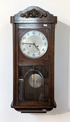 Lot 490 - A 1920s oak wall clock