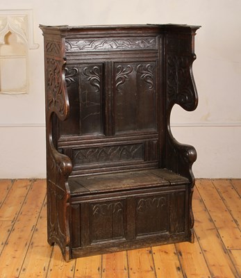 Lot 539 - A 19th century carved oak settle