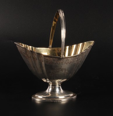 Lot 70 - A George III silver swing-handled sugar basket,...