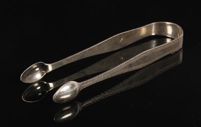 Lot 187 - A pair of George III silver sugar tongs, with...