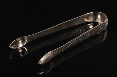 Lot 183 - A pair of George III silver sugar tongs, with...