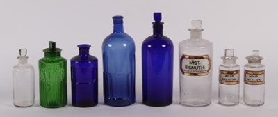 Lot 301 - A collection of glass apothecary bottles,...