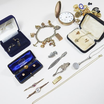 Lot 387 - A silver gilt charm bracelet, suspended with 9...