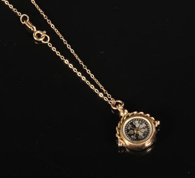 Lot 204 - A 9 carat yellow gold chain and compass...