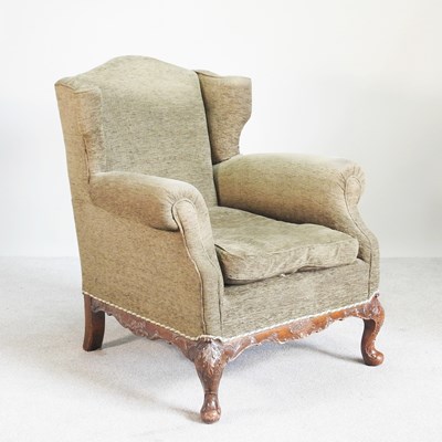 Lot 94 - An early 20th century green upholstered wing...