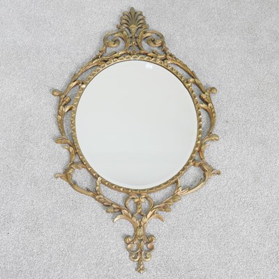 Lot 491 - A French gilt cast metal wall mirror, of oval...