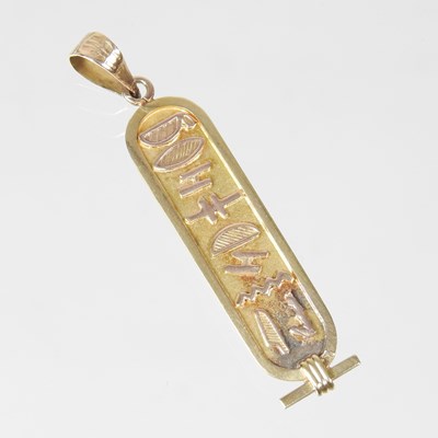 Lot 600 - A gilt pendant, decorated with hieroglyphs,...