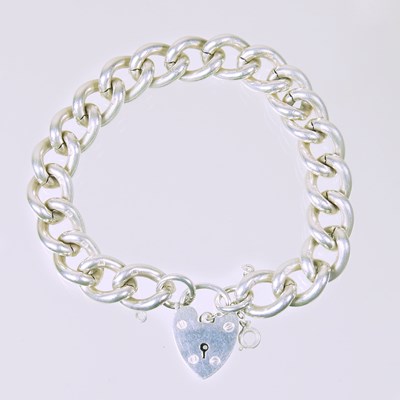 Lot 424 - A heavy silver curb link bracelet, with a...