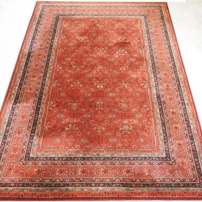 Lot 324 - A modern Persian style rug, on a red ground,...