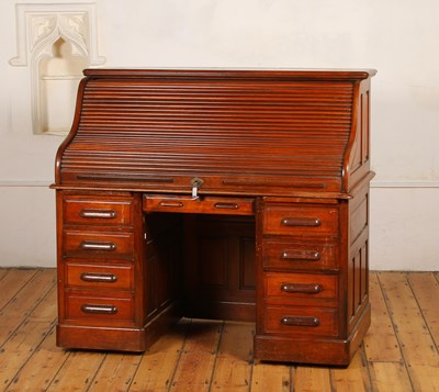 Lot 84 - An early 20th century oak roll top desk, the...