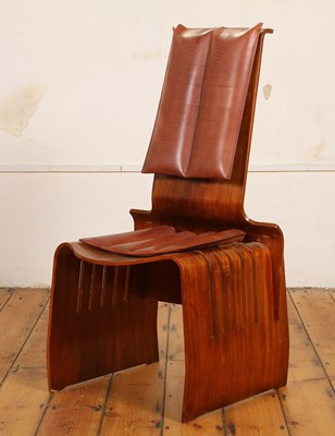 Lot 398 - A modern bent plywood chair, with leather pad...