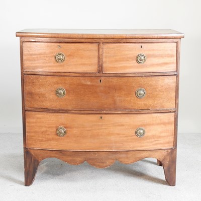 Lot 264 - A small 19th century mahogany bow front chest...