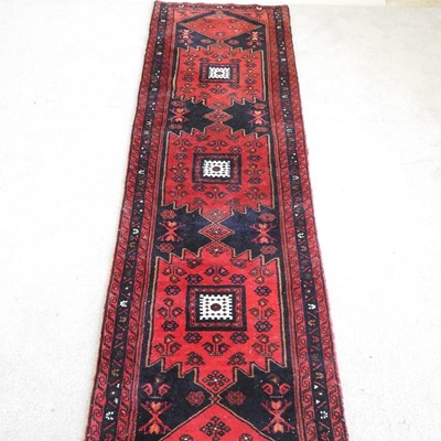 Lot 577 - A Persian runner, with geometric designs, on a...