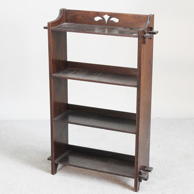 Lot 514 - An Arts and Crafts oak open bookcase