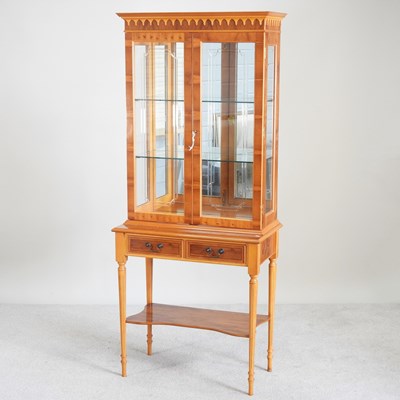 Lot 666 - A reproduction yew wood glazed cabinet on stand