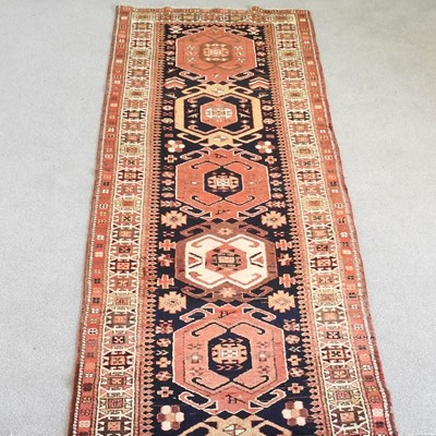 Lot 204 - A Persian heriz runner, with a row of five...