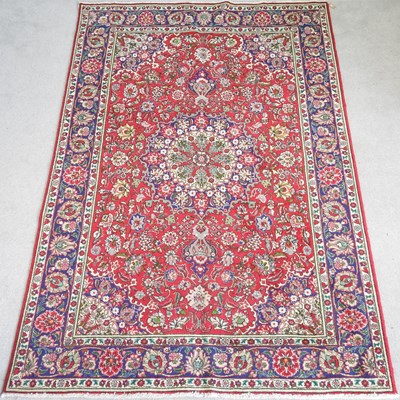 Lot 297 - A large Persian tabriz carpet, with foliate...