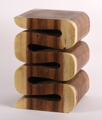Lot 477 - An Indonesian carved teak stool, of a flowing,...