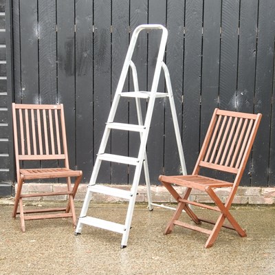 Lot 256 - A pair of teak folding garden chairs, together...