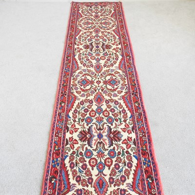 Lot 498 - A Persian runner, with scrolling foliate...