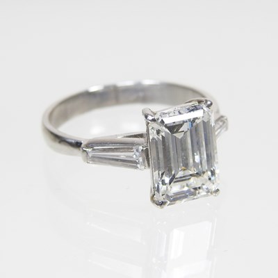 Lot 103 - An impressive platinum set emerald cut diamond...