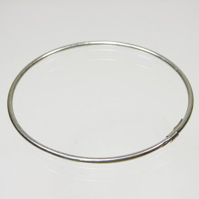 Lot 222 - An Italian 9 carat white gold bangle, of plain...