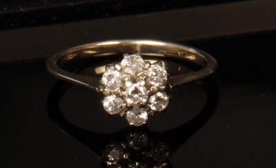 Lot 27 - An 18 carat white gold diamond cluster ring,...