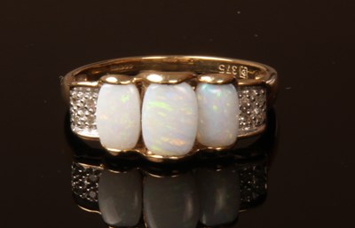 Lot 45 - A 9 carat yellow gold opal trilogy ring, size...