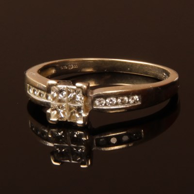 Lot 78 - An 18 carat white gold four princess cut...