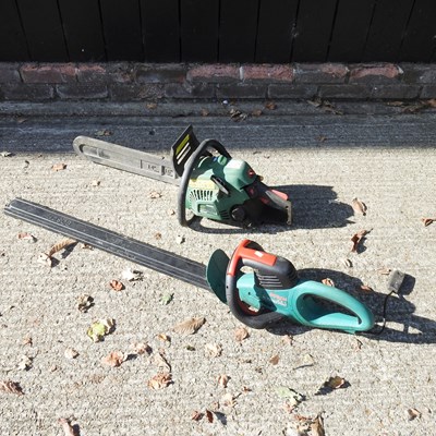 Lot 523 - A petrol chainsaw, together with an electric...