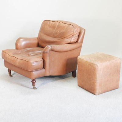 Lot 166 - A brown leather upholstered armchair, bu...