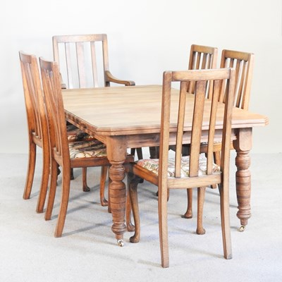 Lot 560 - An Edwardian walnut wind-out extending dining...